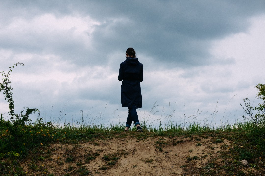 girl standing against sky in a field